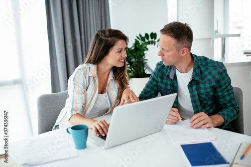 Husband and wife preparing bills to pay. Young couple having financial problems..