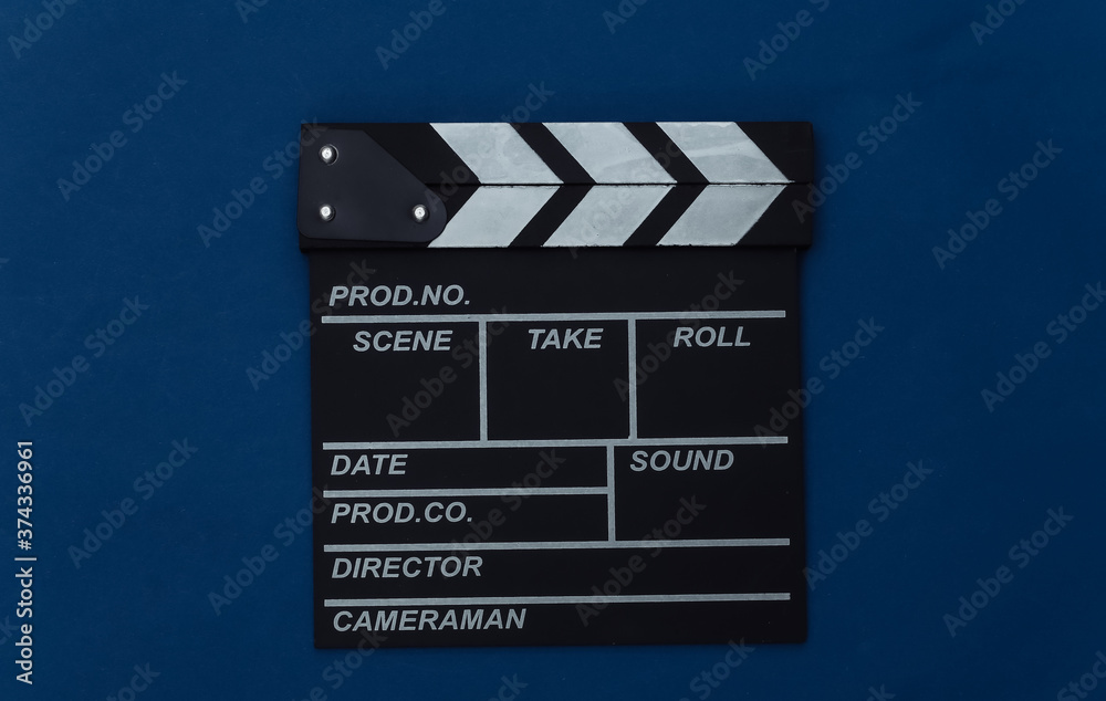 Movie clapper board on classic blue background. Filmmaking, Movie production, Entertainment industry. Color 2020. Top view
