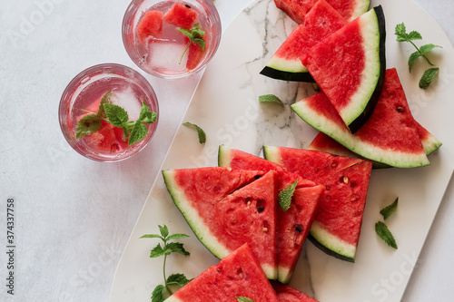 Watermelon slices and some drinks with watermelon and mint leaves