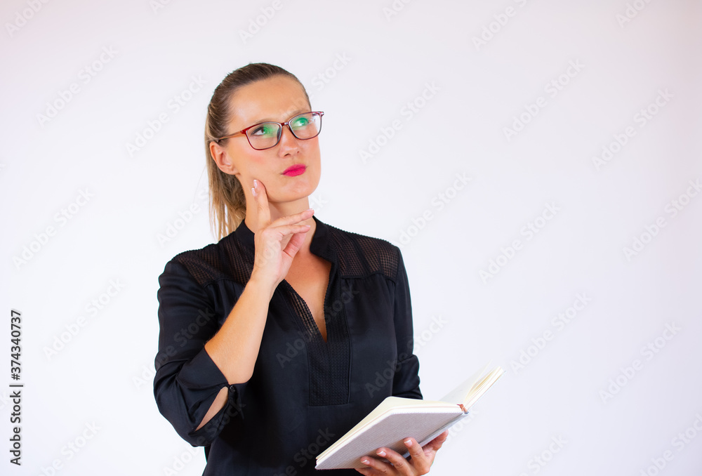 Pretty businesswoman with a notebook with serious gesture Pretty businesswoman with a notebook with serious gesture