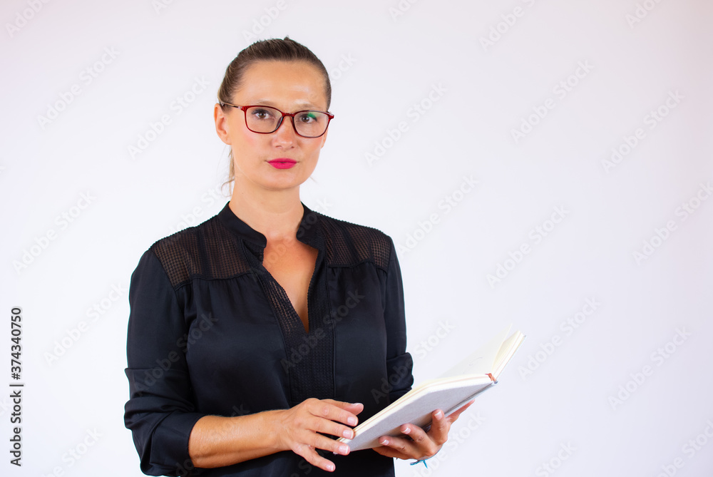 Pretty businesswoman with a notebook on white background