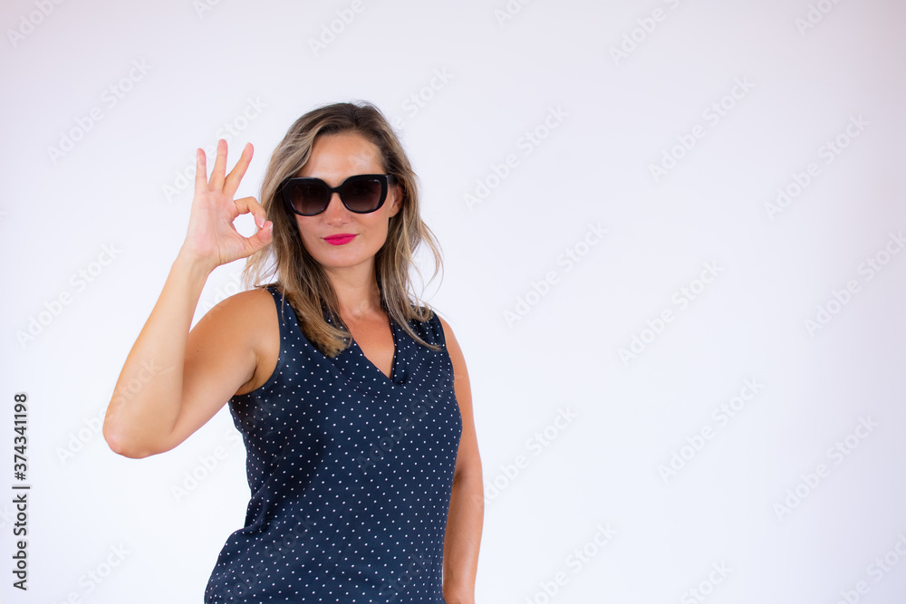Beautiful woman in blue shirt and sunglasses gesturing Beautiful woman in blue shirt and sunglasses gesturing