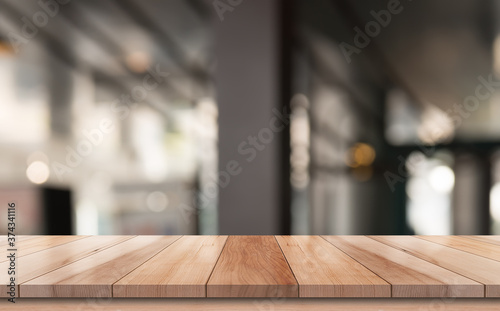 Wooden top table with bokeh light effect and blur restaurant on background, blur background  © DEEP PIXEL