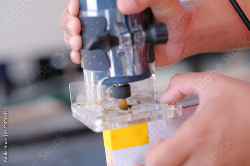 Young carpenter using a laminate trimmer