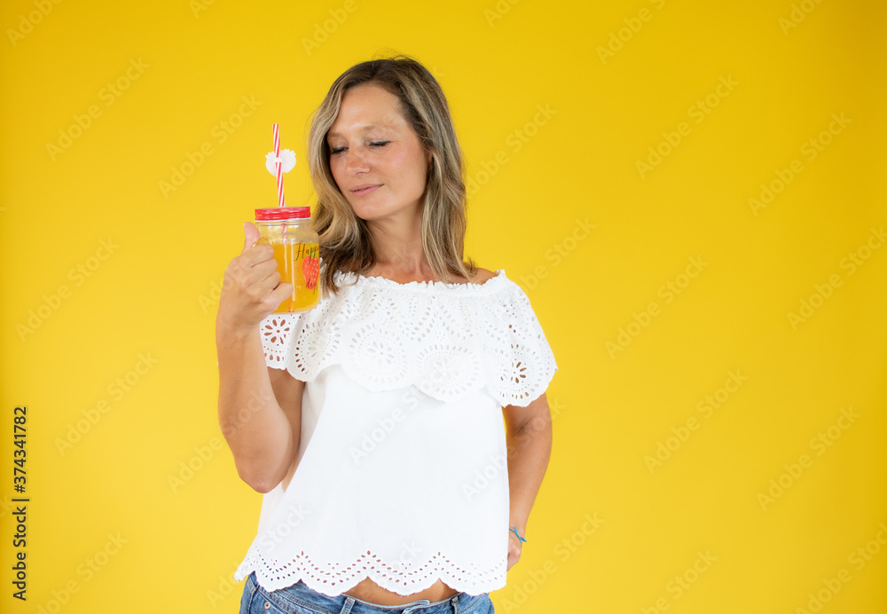 Beautiful woman in white shirt with an orange juice Beautiful woman in white shirt with an orange juice