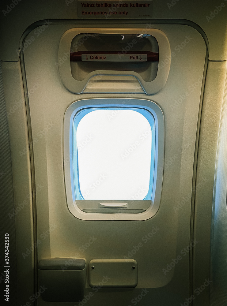 Fototapeta premium airplane window in flight. view of a small airplane window.