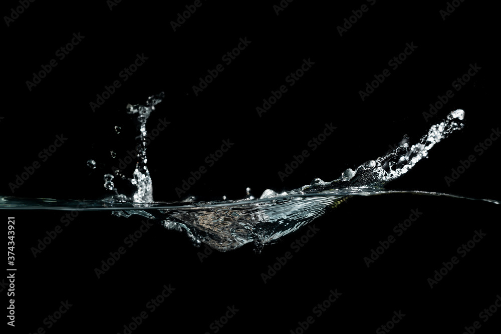 close up of water waves splash and bubbles isolated on black background.