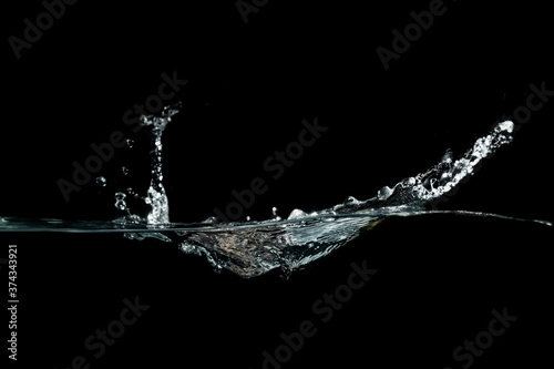 close up of water waves splash and bubbles isolated on black background. © Suprachai
