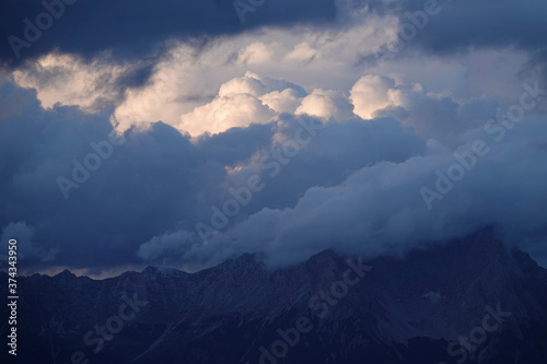 sunrise with dark clouds and sunlight over the mountains © Chamois huntress