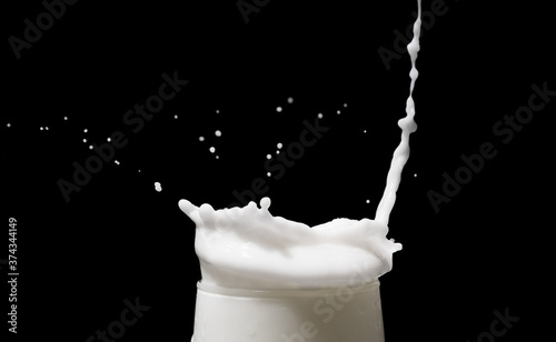 white milk splash isolated on black background