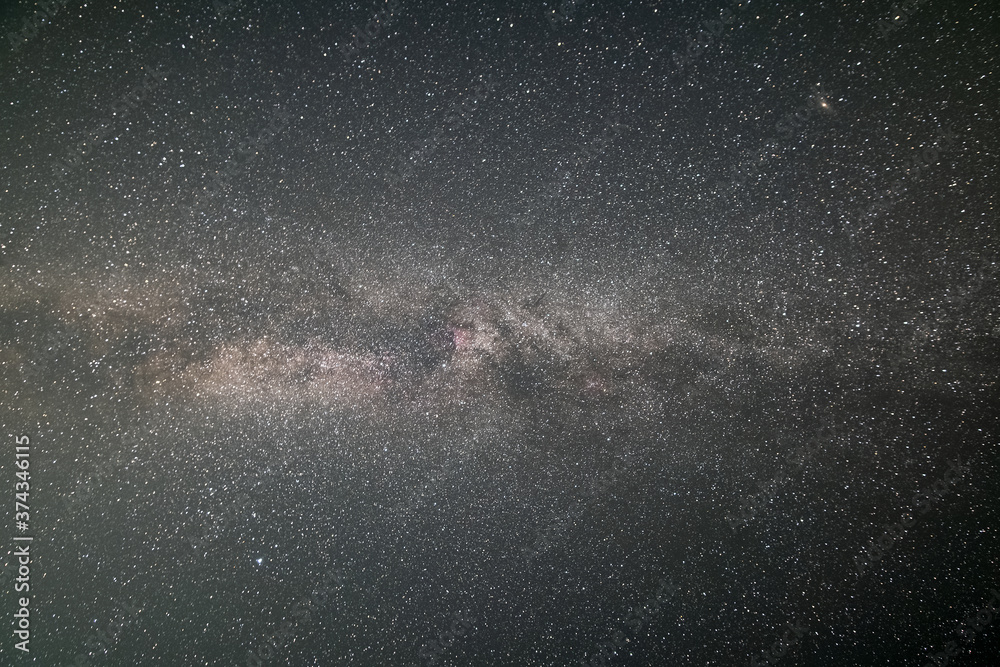 Fototapeta premium Black night stars covered sky with bright Milky Way galaxy.