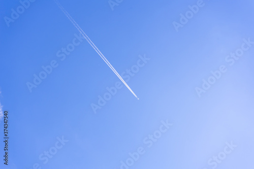 clear blue sky background with a plane. tone blue background. tone blue wallpaper.