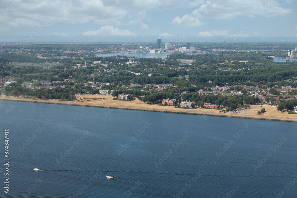 Aerial view Dutch city Almere between lakes Markermeer and Gooimeer