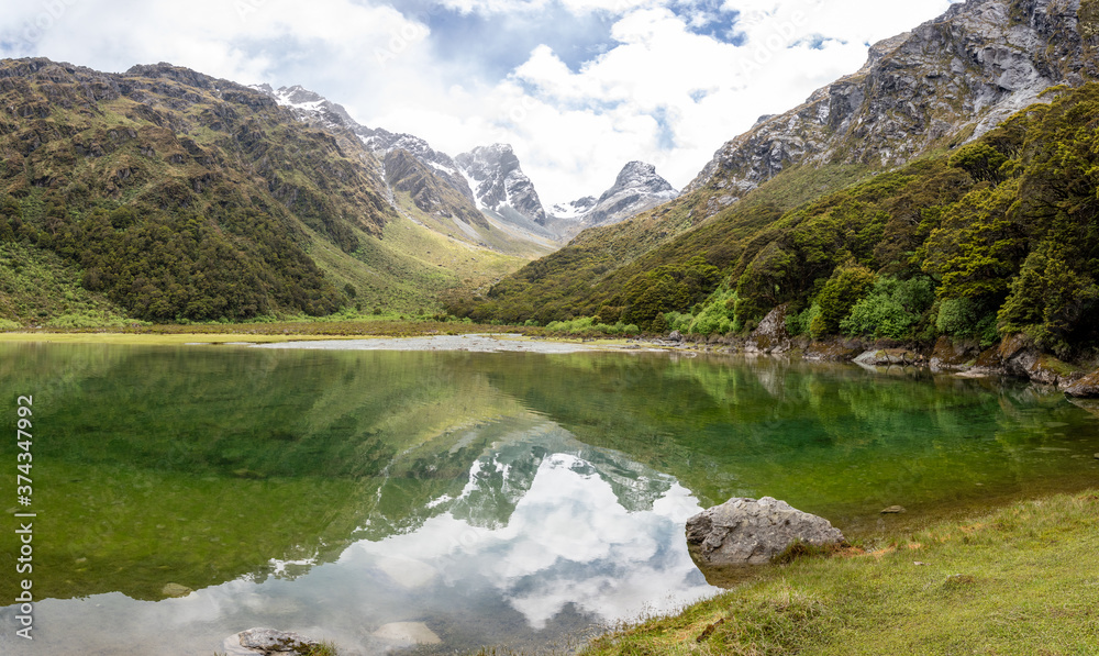 Reflection of Emily Peak in Lake Mackenzie at the famous Routeburn Track, Fjordland National Park, Southland/New Zealand