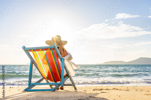 Woman sitting on a chair at the beach photo