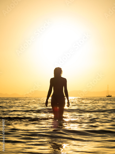 Woman in swiming suit posing on the beach