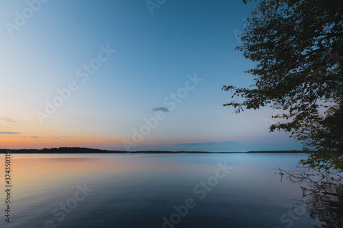 Obraz na płótnie Calm lake water at sunset w salonie