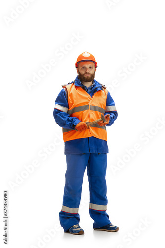 Handsome contractor, builder in face mask isolated over white studio background. Concept of professional occupation, work, job, building, investment. Copyspace for ad, text. Caucasian man wearing