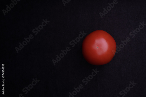 Beautiful natural tomatoes on a black background