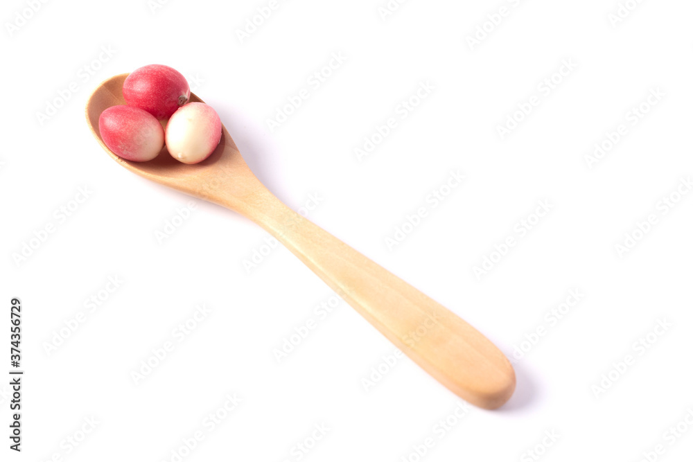 Mango yawning lime in wooden spoon on white background Mango yawning lime in wooden spoon on white background