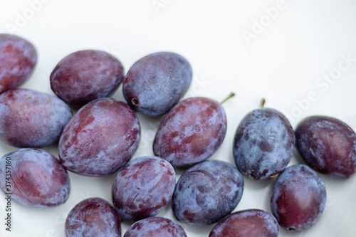 close up of prunes or plums violet fruit isolated on white background. 
