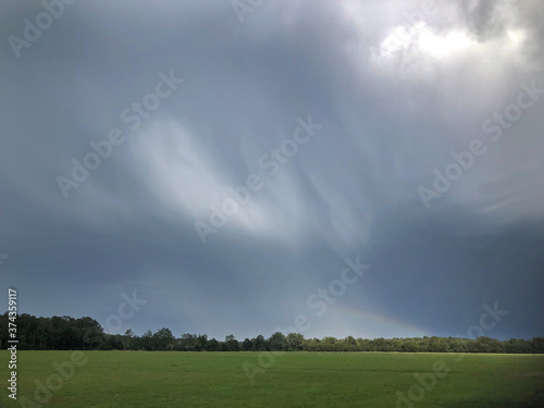 Rain clouds. Threatning Thunderclouds. Havelte Drenthe Netherlands. Holtingerveld. Rainbow. photo