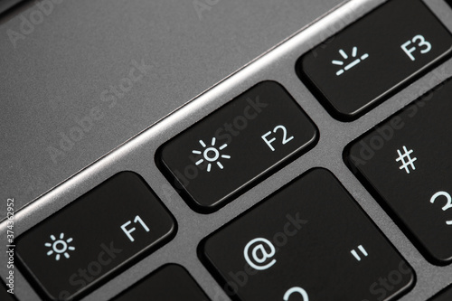 keyboard buttons and laptop fragments in black and silver, background