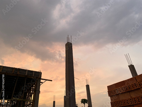 Home construction with wooden scaffolding for building under sunset