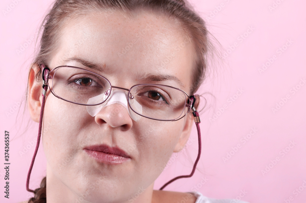 A girl with glasses, her nose is sealed with a plaster. Beautiful girl with glasses. The trauma on the nose is sealed with a plaster. The wound on the nose was sealed with a plaster. A girl with glasses, her nose is sealed with a plaster. Beautiful girl with glasses. The trauma on the nose is sealed with a plaster. The wound on the nose was sealed with a plaster.