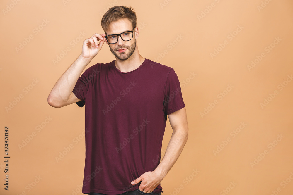 Portrait of a handsome man in glasses against beige background with copy space. Smiling guy in casual standing in casual isolated. Successful hispanic man looking at camera. Portrait of a handsome man in glasses against beige background with copy space. Smiling guy in casual standing in casual isolated. Successful hispanic man looking at camera.