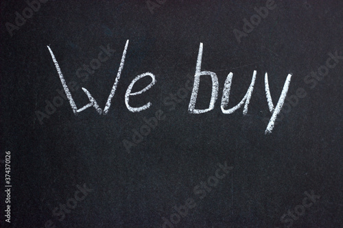 The inscription on the chalkboard "We buy". A common phrase in business and finance