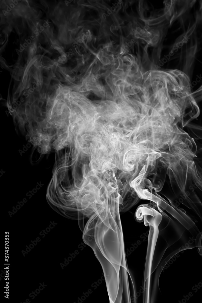 White smoke fragments on a black background.