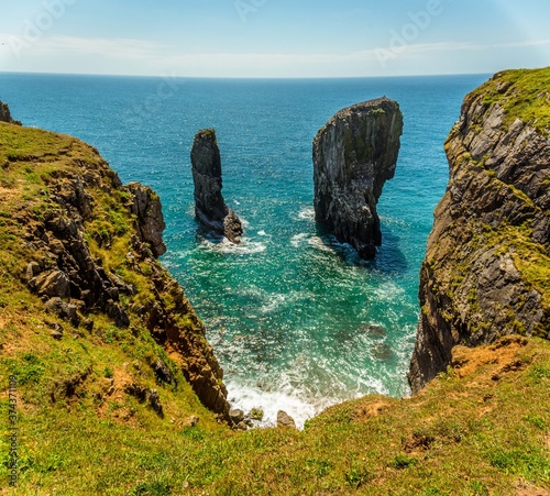 A classic view of Stack Rocks on the Pembrokeshire coast, Wales near Castlemartin in early summer photo