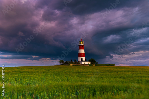 lighthouse on the coast with stormy clouds