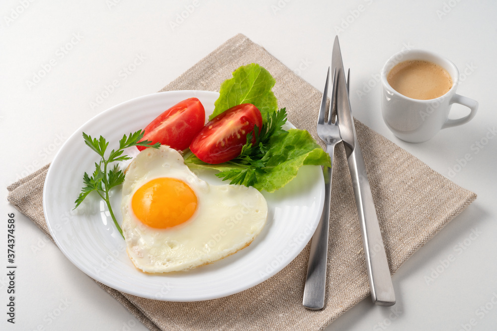 Food poster - Healthy and hearty breakfast. Close-up of a fried eggs, tomato, herbs and espresso coffee. Served on a white table with a linen napkin and cutlery. Food poster - Healthy and hearty breakfast. Close-up of a fried eggs, tomato, herbs and espresso coffee. Served on a white table with a linen napkin and cutlery.