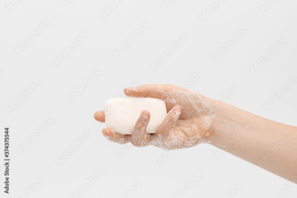 Bar of white soap in a woman's hand. Bar of white soap in a woman's hand.