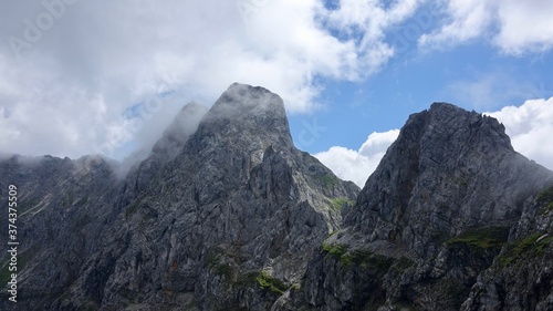 Fototapeta Naklejka Na Ścianę i Meble -  Wandern im Hochgebirge über den Wolken, Alpenwanderung in Österreich