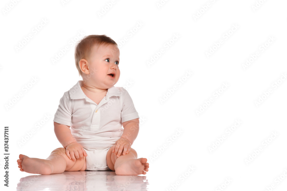 Intrigued baby in a white bodysuit looks to the side on a white background. Intrigued baby in a white bodysuit looks to the side on a white background.