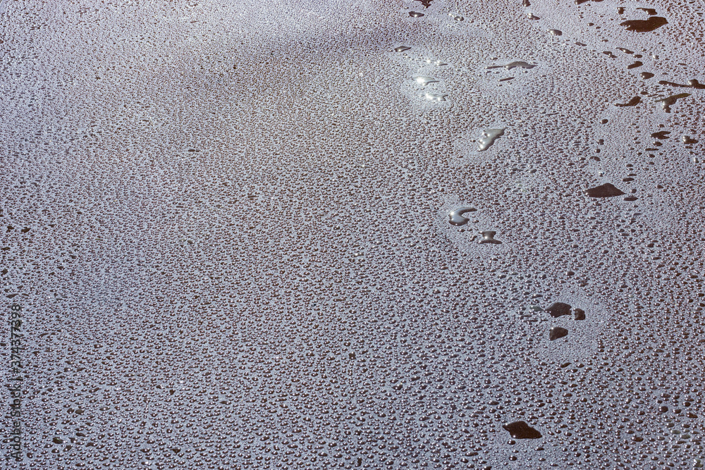 Water drops on the new asphalt road surface. Water drops on the new asphalt road surface.
