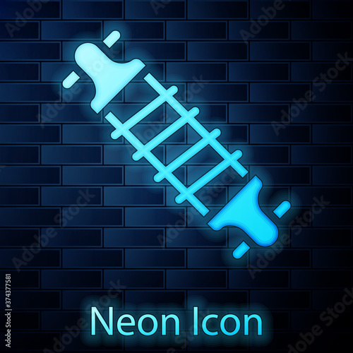 Glowing neon Bicycle suspension icon isolated on brick wall background. Vector.