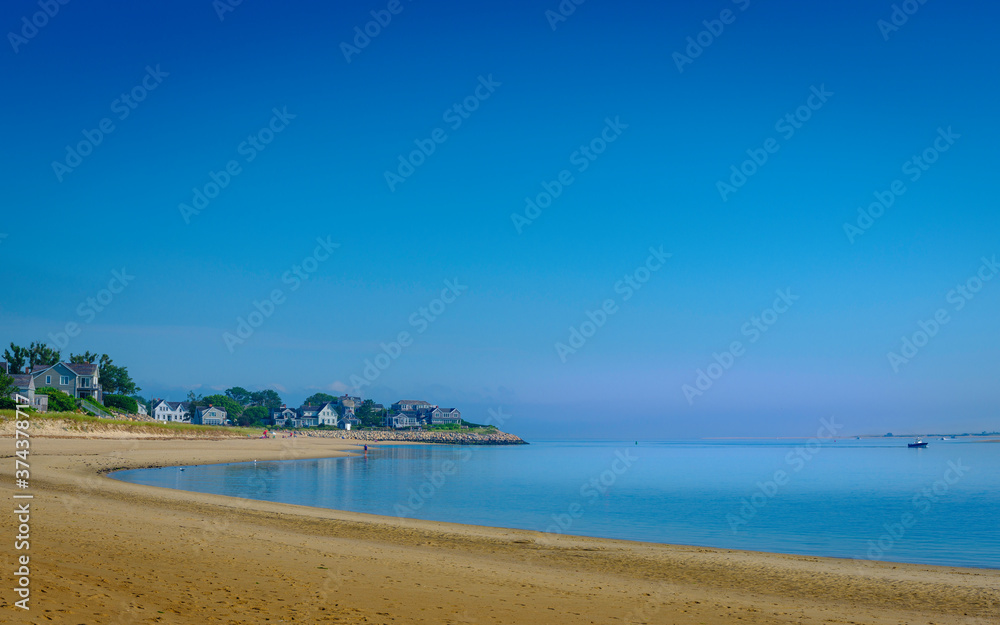 Tranquil Coastline Seascape with Clear Blue Sky over Curving Sandy Beach on Cape Cod
