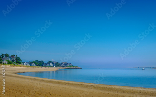 Tranquil Coastline Seascape with Clear Blue Sky over Curving Sandy Beach on Cape Cod