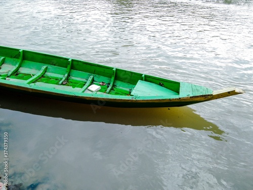 Floating boat on the riverside.