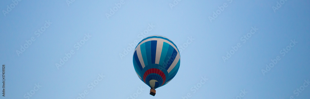 Fototapeta premium Big balloon flies against the sky