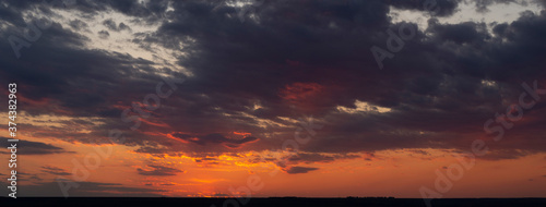 Purple-magenta clouds. Tragic gloomy sky. Landscape with bloody sunset. Fantastic skies on the planet earth. Twilight, nightfall. Blackout.