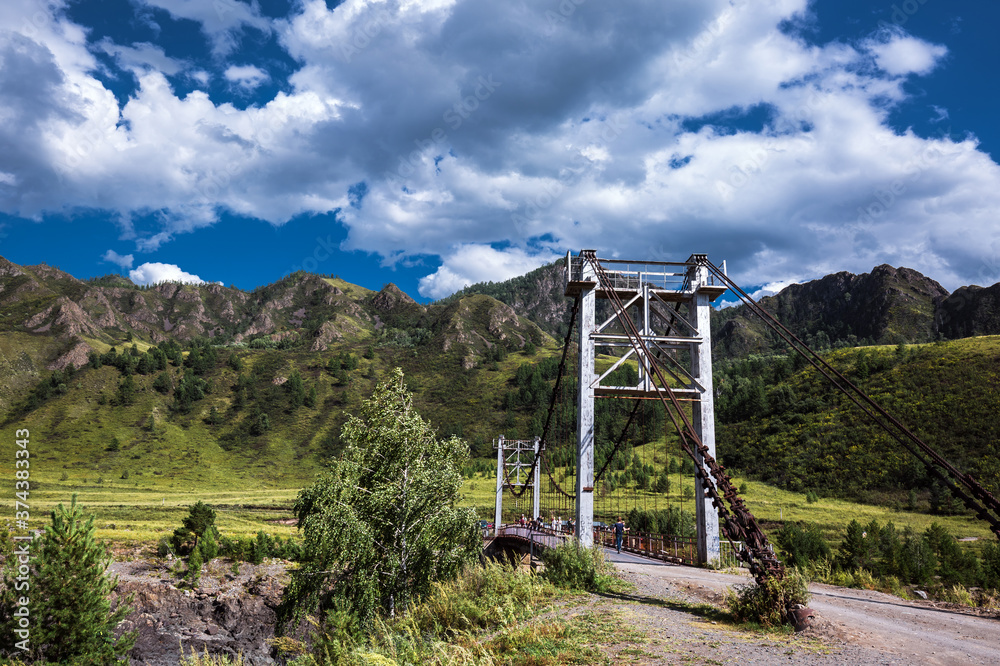 Mountain landscape with a bridge over the Katun river. Altai Republic Mountain landscape with a bridge over the Katun river. Altai Republic