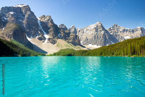 Beautiful Canadian famous turquoise Moraine Lake, Banff National Park, AB. The view on the valley of the ten peaks. Blue sky in the background.