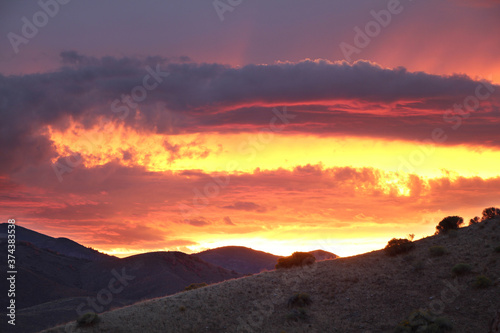 Extremely vibrant sunset over the desert hills of Henefer, Utah