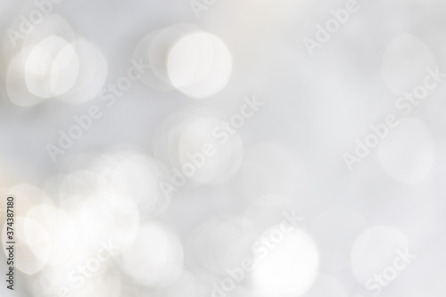 Abstract blurred silver bokeh soft light background and texture. Christmas and Happy new year on blurred bokeh with snowfall banner background.