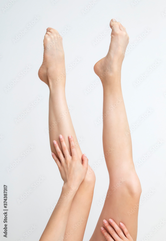 Perfect clean female feet . Beautiful and elegant groomed girl hand touches her feet . Spa ,scrub and foot care . Perfect clean female feet . Beautiful and elegant groomed girl hand touches her feet . Spa ,scrub and foot care .